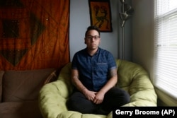 In this photo taken Thursday, May 5, 2016 Joaquin Carcaño is shown at his home in Carrboro, N.C. Carcaño, a 27-year-old transgender man, works for the University of North Carolina at Chapel Hill.