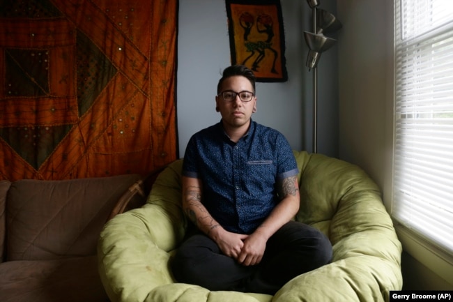 In this photo taken Thursday, May 5, 2016 Joaquin Carcaño is shown at his home in Carrboro, N.C. Carcaño, a 27-year-old transgender man, works for the University of North Carolina at Chapel Hill.