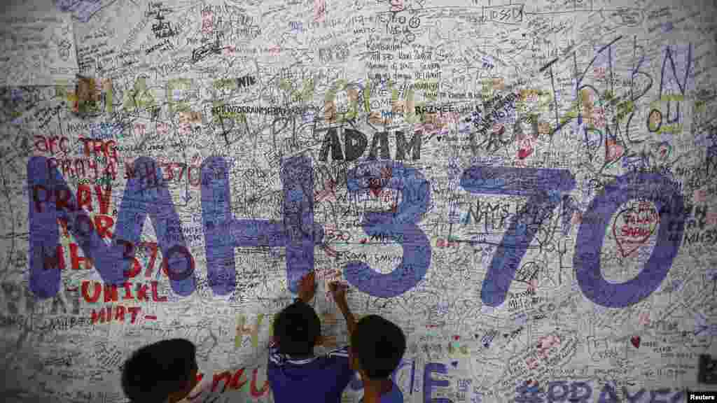 Des enfants écrivent des messages d&#39;espoir pour les passagers du Vol MH370, le 14 juin 2014.