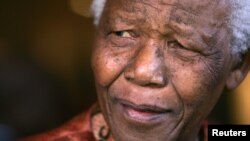 Former President Nelson Mandela smiles as he formally announces his retirement from public life in Johannesburg, South Africa, June 1, 2004.