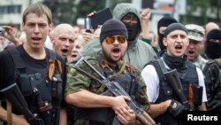 Armed pro-Russian separatists of the self-proclaimed Donetsk People's Republic pledge an oath during ceremony in the city of Donetsk, June 21, 2014. 