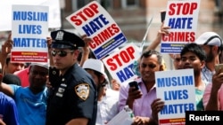 Community members take part in a protest to demand stop hate crime during the funeral service of Imam Maulama Akonjee, and Thara Uddin in the Queens borough of New York City, Aug. 15, 2016. 