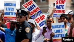 FILE - Community members take part in a protest to demand stop hate crime during the funeral service of Imam Maulama Akonjee, and Thara Uddin in the Queens borough of New York City, Aug. 15, 2016. 