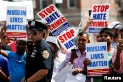 Community members take part in a protest to demand stop hate crime during the funeral service of Imam Maulama Akonjee, and Thara Uddin in the Queens borough of New York City, Aug. 15, 2016.