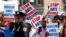 FILE - Community members take part in a protest against hate crimes during the funeral of Imam Maulama Akonjee and Thara Uddin in Queens, New York, Aug. 15, 2016. An attacker fatally shot the imam and his assistant on a street in Queens.