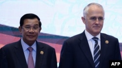 FILE - Cambodia's Prime Minister Hun Sen and Australian Prime Minister Malcolm Turnbull pose for a photo at an ASEAN summit in Kuala Lumpur, Malaysia, Nov. 22, 2015.