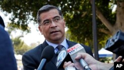 FILE - California Attorney General Xavier Becerra talks to reporters after a news conference at University of California, Los Angeles, Aug. 2, 2018.