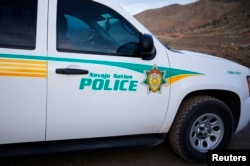 A Navajo police officer patrols in his vehicle on the Navajo Reservation, by a remote section of the Grand Canyon near Little Colorado River, Arizona June 23, 2013