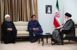 In this picture released by an official website of the office of the Iranian supreme leader, Supreme Leader Ayatollah Ali Khamenei, right, meets Pakistani Prime Minister Imran Khan, center, with Iranian President Hassan Rouhani, in Tehran, Iran, Oct. 13, 2019.