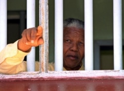 FILE: African National Congress (ANC) president Nelson Mandela stares out of the window of the prison cell he occupied on Robben Island for much of his 27 year incarceration.