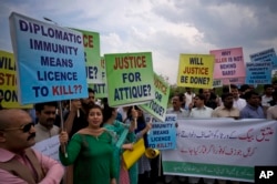 FILE - Pakistani protesters stage a rally demanding a trial for the American diplomat involved in a vehicle crash that killed one person, in Islamabad, Pakistan, April 10, 2018.