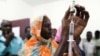 FILE - Staff members of the Teaching Hospital receive a vaccination for yellow fever in El Geneina, West Darfur, Nov. 14, 2012.