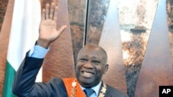 Laurent Gbagbo waves after being formally sworn-in as Ivorian president during a ceremony in Abidjan, 04 Dec 2010