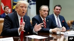 President Donald Trump speaks during a meeting with House Republicans in the Roosevelt Room of the White House in Washington, Feb. 16, 2017. From left are, Trump, Rep. Chris Collins, R-N.Y., and Rep. Duncan Hunter, R-Calif. Both Collins and Hunter are under indictment.