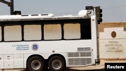 Immigration and Customs Enforcement detainees arrive at FCI Victorville federal prison in Victorville, Calif., June 8, 2018.