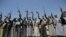 FILE - Shi'ite Houthi tribesmen hold their weapons as they chant slogans during a tribal gathering showing support for the Houthi movement, in Sana'a, Yemen.
