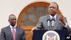 Kenya's President Uhuru Kenyatta, right, accompanied by Deputy President William Ruto, left, speaks to the media about the upcoming visit of U.S. President Barack Obama, among other issues, at State House in Nairobi, Kenya, July 21, 2015.