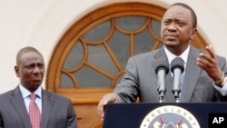 FILE - Kenya's President Uhuru Kenyatta, right, accompanied by Deputy President William Ruto, left, speaks to the media in Nairobi, Kenya, July 21, 2015.