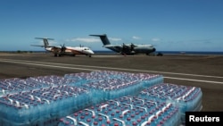 Supplies to be transported to Mayotte lie on the tarmac near parked aircrafts, in the aftermath of Cyclone Chido, at the military airbase 181 in Sainte Marie in Reunion Island, France, Dec. 17, 2024. 