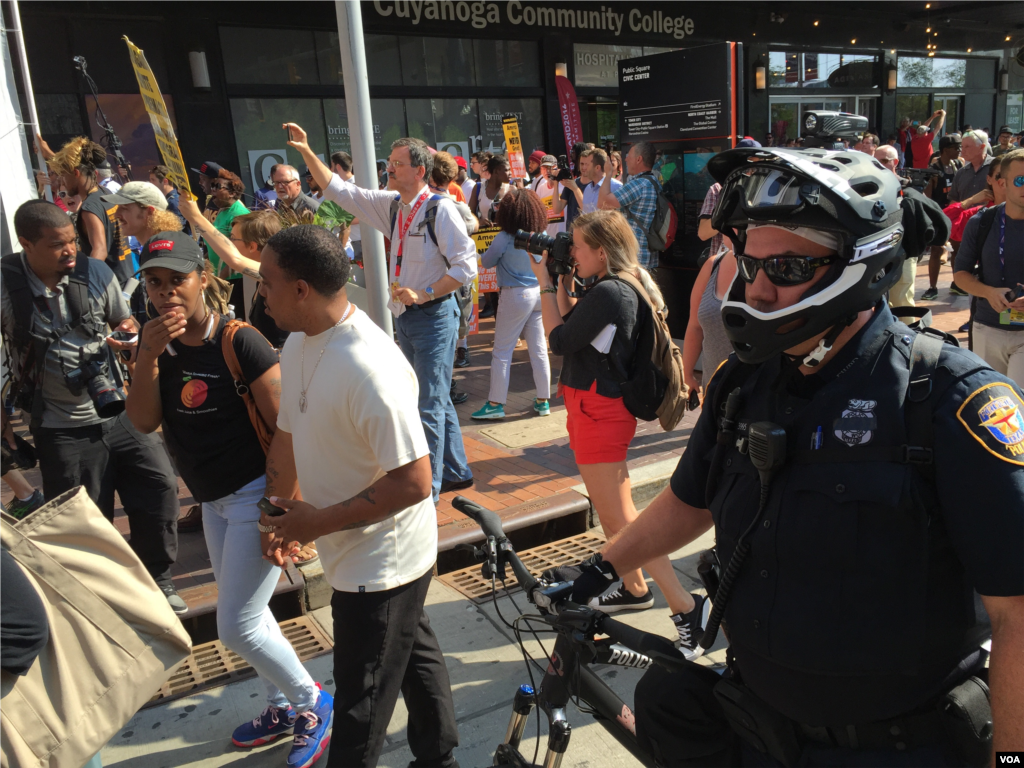 Black Lives Matter protesters are taken away by police outside the convention hall on July 19, 2016 (VOA/Mia Bush)