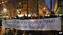 Students hold a banner, which reads: "Trial and punishment to the murderers of Manuel, enough of police repression!", during a rally in downtown Santiago, August 26, 2011