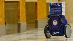 RollBot, a toilet paper-carrying droid developed by Charmin and Unit 9, carries a roll of toilet paper through a bathroom, Monday, Jan. 6, 2020, in Las Vegas. (AP Photo/Jack Dempsey)