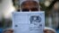 A Pakistani man holds a pamphlet, allegedly distributed by the Islamic State (IS), in the northwestern Pakistani city of Peshawar, Sept. 3, 2014 .