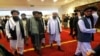 FILE - Taliban co-founder Mullah Abdul Ghani Baradar, center, arrives with other members of the Taliban delegation for attending an international peace conference in Moscow, Russia, Apr. 21, 2021.