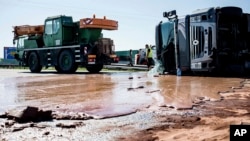 Tons of liquid milk chocolate are spilled and block six lanes on a highway after a truck transporting it overturned near Slupca, in western Poland, on Wednesday, May 9, 2018. (AP Photo)