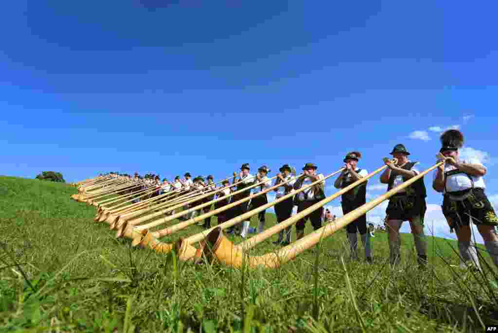 Alphorn players take part during a mass performance of 300 alphorn blowers in Nesselwang, southern Germany.