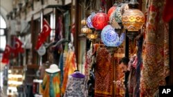 A shop worker waits for customers in a market in Istanbul, Sept. 13, 2018. 