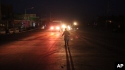 Afghan police black a road leading to the site of an explosion, in Kabul, Afghanistan Monday, Aug. 1, 2016. A strong explosion took place early Monday near a guesthouse for foreigners in Kabul, an Afghan police official said.