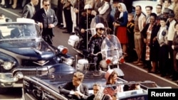 FILE - President John F. Kennedy and Mrs. John F. Kennedy, and Texas Governor John Connally ride through Dallas moments before Kennedy was assassinated, Nov. 22, 1963.