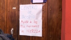 Un letrero señaliza un centro de acopio en Caracas para los afectados por las lluvias en el estado Mérida, en los Andes venezolanos. [Foto: VOA]