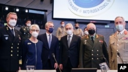 From second left, U.S. Deputy Secretary of State Wendy Sherman, NATO Secretary General Jens Stoltenberg, Russia's Deputy Foreign Minister Alexander Grushko, and Deputy Defense Minister Alexander Fomin pose for a photo prior to their meeting in Brussels, Belgium, Jan. 12, 2022.