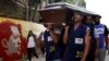 FILE - Relatives and basketball teammates of a crime victim carry his coffin prior to his burial in Caracas, Venezuela, Nov. 25, 2015. 