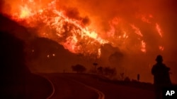 FILE - The Thomas fire burns through Los Padres National Forest near Ojai, California, Dec. 8, 2017. 