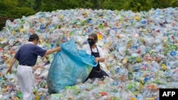 This photo taken on July 16, 2018 shows volunteers sorting out plastic bottles at a recycling centre run by a non-profit Buddhist organisation in Taipei. Taiwan started recycling plastic more than a decade ago and today it boasts more than 70 percent recy