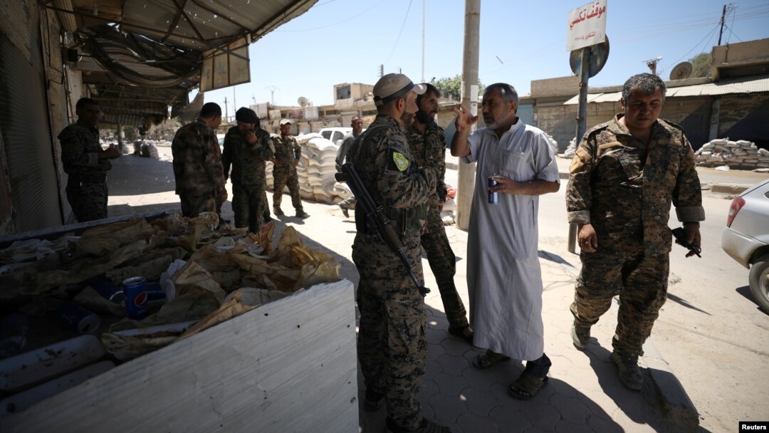 Syrian Democratic Forces fighters gather in the town of Tabqa, Syria, after the SDF captured it from Islamic State militants this week, May 12, 2017.