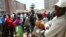 FILE: Customers wait in a queue to withdraw cash from a bank in Harare, Zimbabwe, after the Reserve Bank of Zimbabwe issued new banknotes, Tuesday, Nov, 12, 2019. (AP Photo/Tsvangirayi Mukwazhi)
