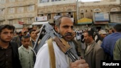 An armed Houthi follower attends a rally against Saudi-led air strikes in Sanaa, June 14, 2015.