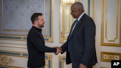 U.S. Secretary of Defense Lloyd Austin, right, and Ukraine's President Volodymyr Zelenskyy shake hands during their meeting in Kyiv, Ukraine, Oct. 21, 2024. (Press Service of the President of Ukraine via AP)