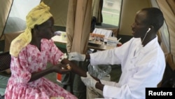 FILE - A woman is given a free HIV/AIDS test in Lira, northern Uganda, Sept. 9, 2007. 