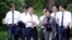South Korean President Moon Jae-in takes a walk with senior presidential secretaries at the Presidential Blue House in Seoul, South Korea, May 11, 2017.