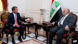 FILE - U.S. Defense Secretary Ash Carter meets with Iraqi Prime Minister Haider al-Abadi in the prime minister's office in Baghdad, Iraq, July 23, 2015. 