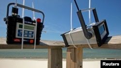 FILE - Air quality monitoring equipment is installed on the pier at the beach on Dauphin Island, Alabama, May 10, 2010, two days after tar balls washed up onshore. 