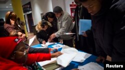 FILE - People attend a job training and resource fair at Coney Island in New York.