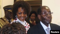 FILE - President Robert Mugabe and his wife Grace arrive to chair ZANU PF's Politburo meeting at the party headquarters in Harare, Feb. 15, 2017. 