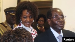 FILE - President Robert Mugabe and his wife Grace arrive to chair ZANU PF's Politburo meeting at the party headquarters in Harare, Feb. 15, 2017. 