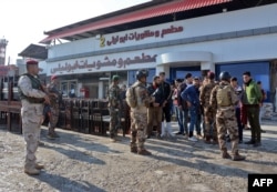 Iraqi security forces inspect the scene of a car bomb explosion the previous night in Mosul, Iraq, Nov. 9, 2018.